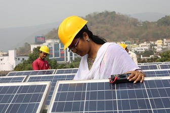 Workers check solar batteries